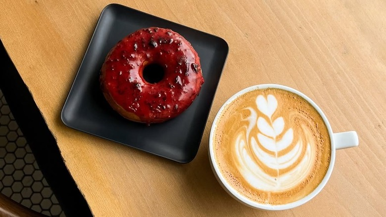 Purple glazed donut text to coffee cup