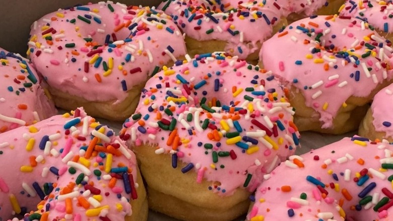 Pink frosted and sprinkles donuts