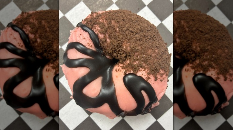 Pink iced donut with chocolate swirl and dusting