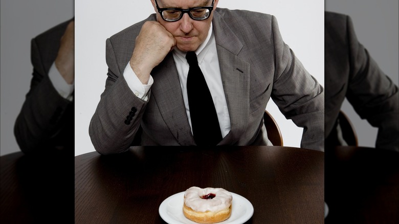 Man judging donut