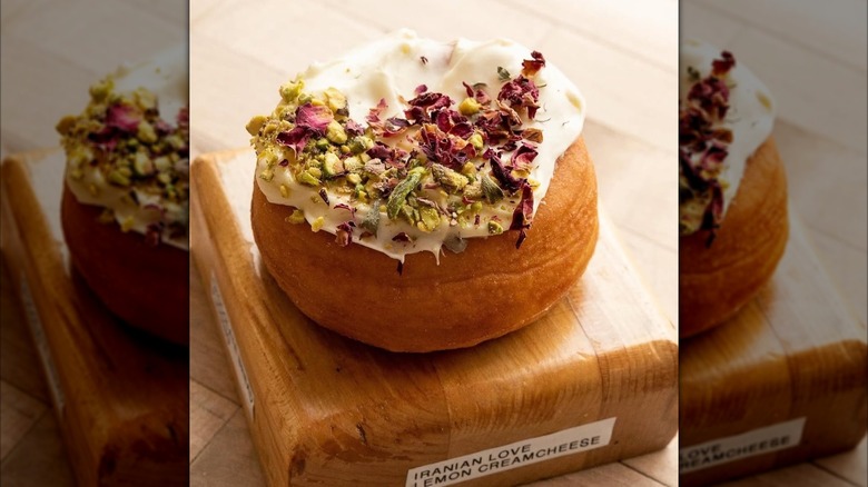 Iced donut with pistachio and rose petals