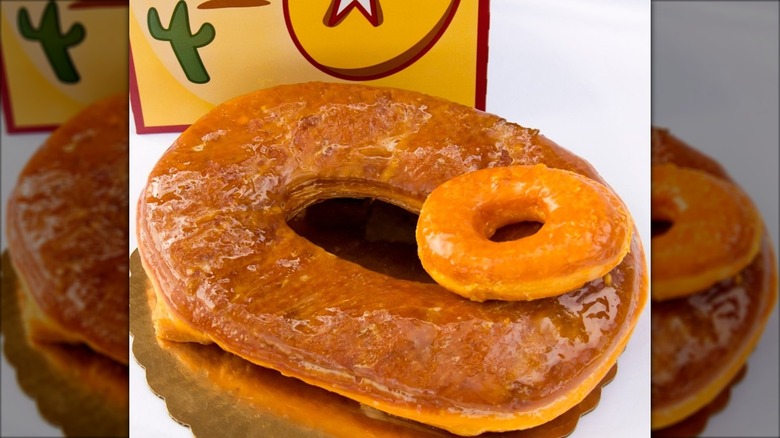 Regular donut on top of very large donut