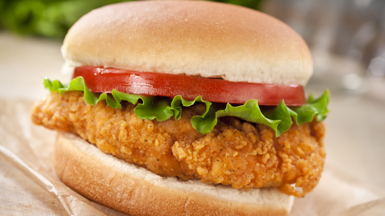 A crispy chicken sandwich with lettuce and tomato