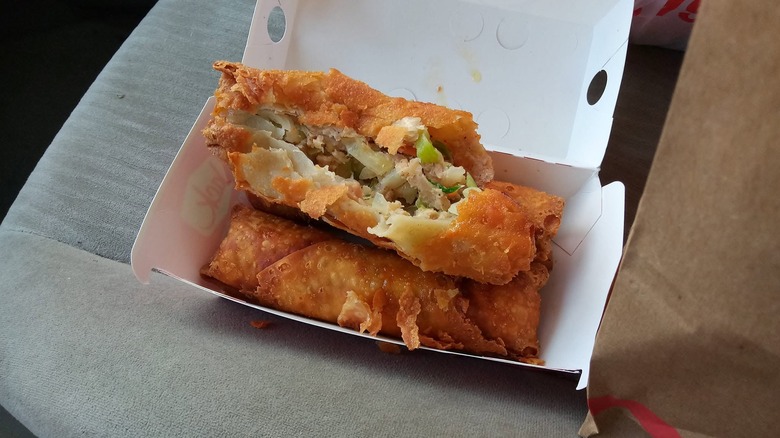 Egg rolls from Jack in the Box in a container with one cracked open