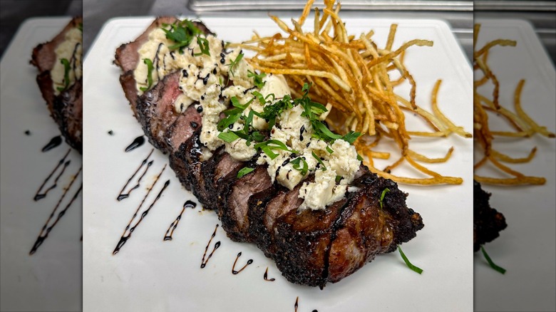 Steak frites on white plate