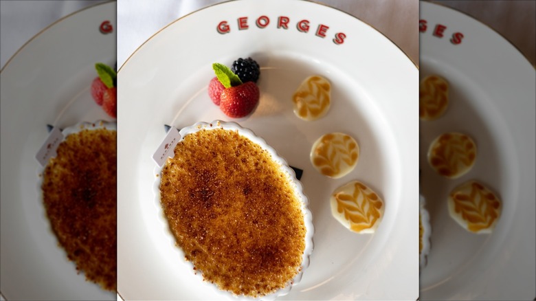 Creme brulee with berries on white George's plate