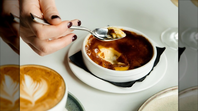 Creme brulee alongside coffee