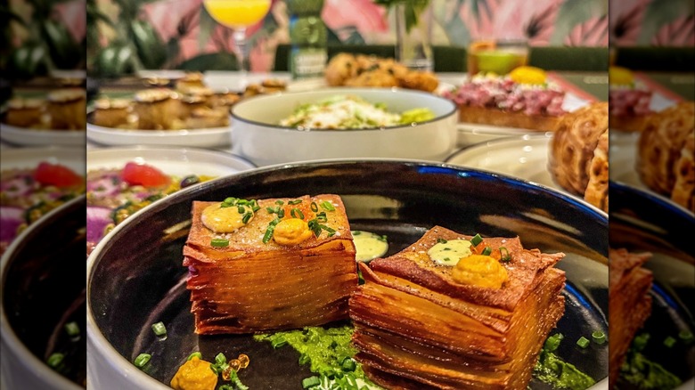 Crispy potatoes pavé dish in foreground