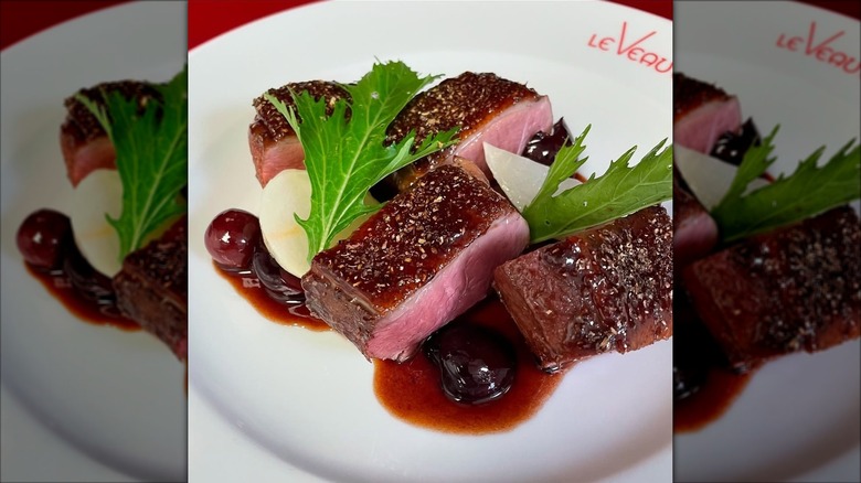 Duck breast served with a  cherry sauce