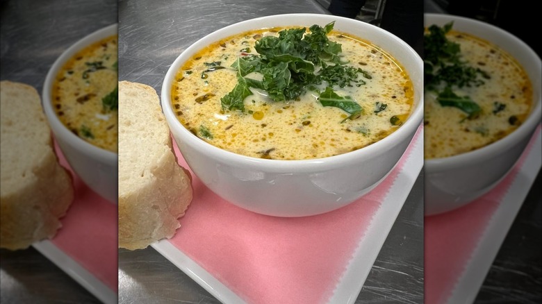 Bowl of soup with greens on top
