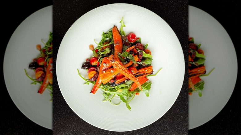 Carrot topped salad with sliced cherry tomatoes