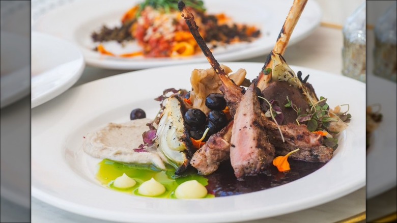 Lamb ribs alongside sauces and spread