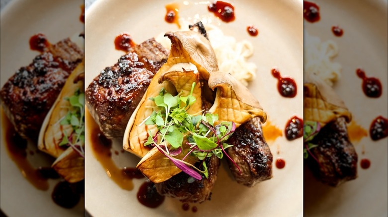 Meat dish with large mushrooms on top