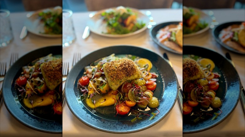 Herb crusted chicken breast on bed of polenta