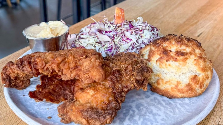 The Wylder fried chicken with sides of slaw and biscuit