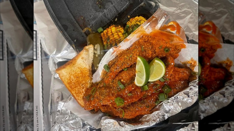 The Real Aunt Irene's Kitchen fried chicken in takeaway container with side of corn on the cob and toast