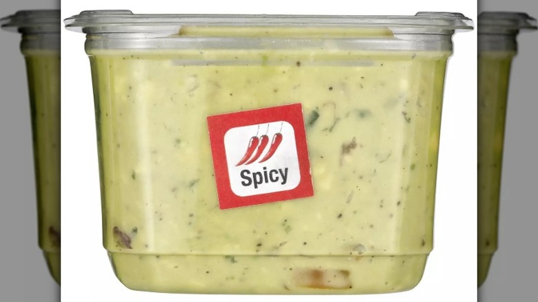 Clear container of guacamole with red and white "spicy" sticker