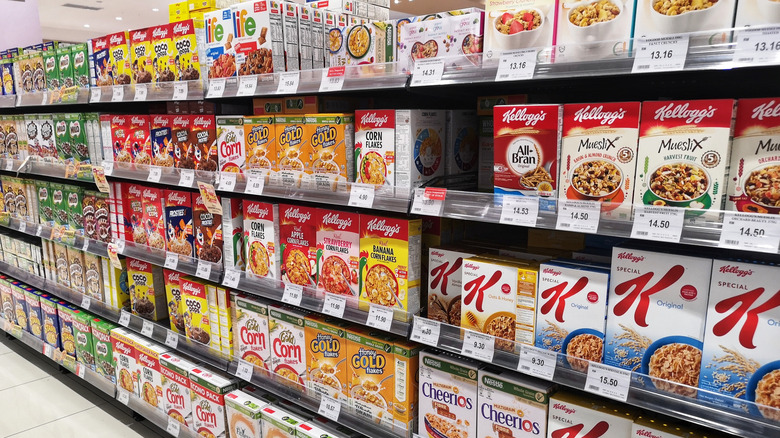 Assorted boxes of cereal on grocery store shelf