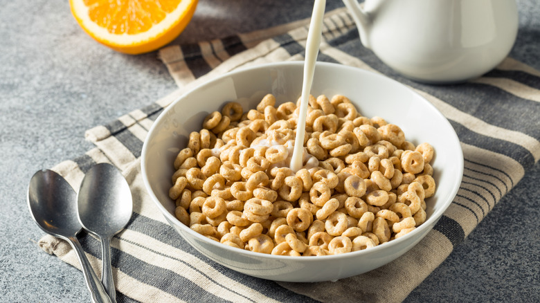 Milk pouring into a bowl of Cheerios