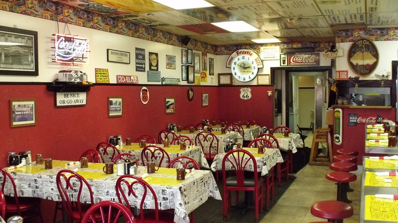 Interior dining room of Roxy Cafe with red walls and chairs
