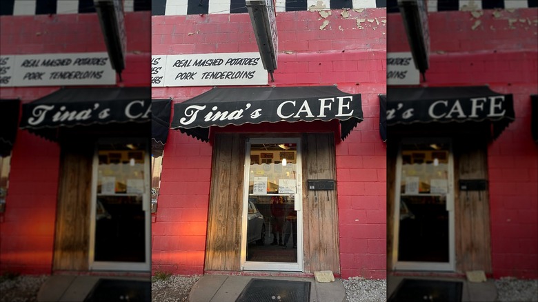 Tina's Cafe & Catering exterior with red walls and a black and white sign