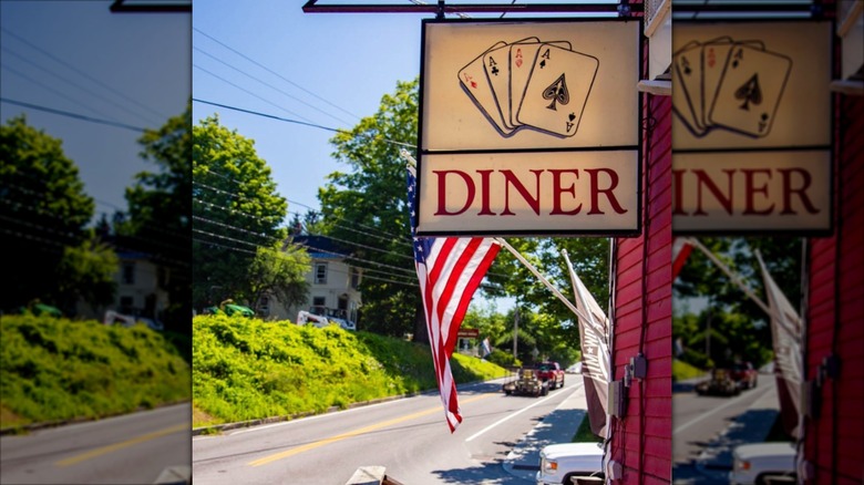 Four Aces diner exterior signage with a flag