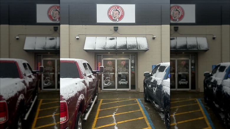 Deaner's Diner exterior with parking lot and two trucks with snow on