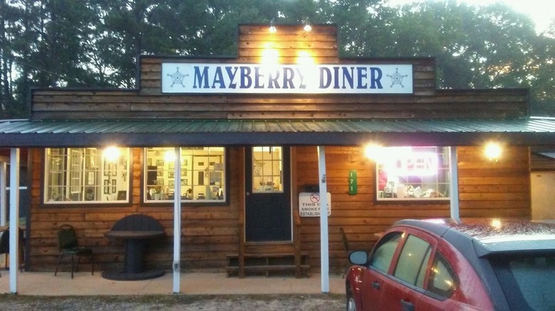 Mayberry Diner exterior lit up with a car outside