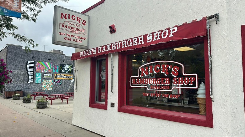 Nick's Hamburger Shop exterior and window with a dark red and white sign