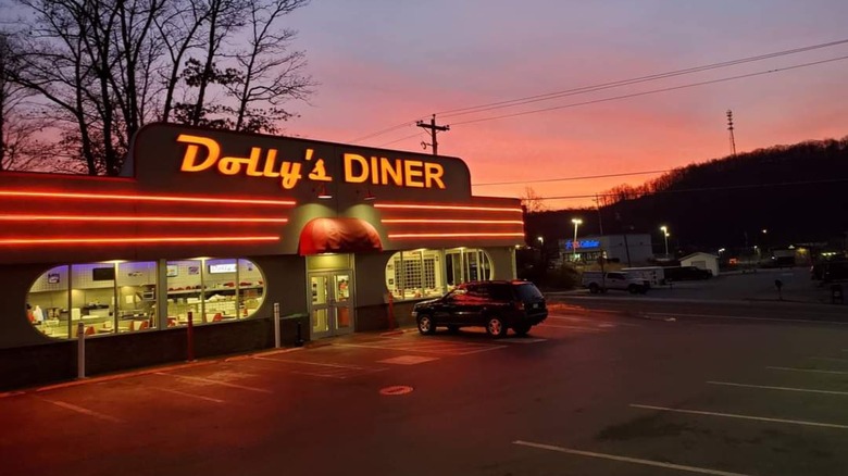 Dolly's Diner exterior at night at sunset with neon sign lit