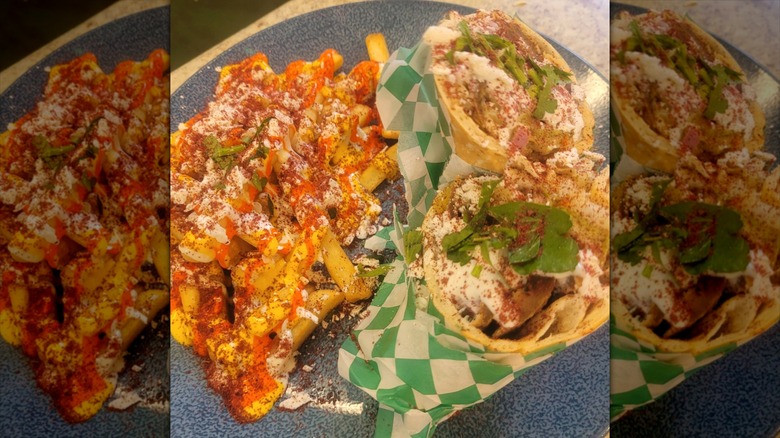 Gyro and side of smothered French fries at Chania Greek Restaurant on a blue plate