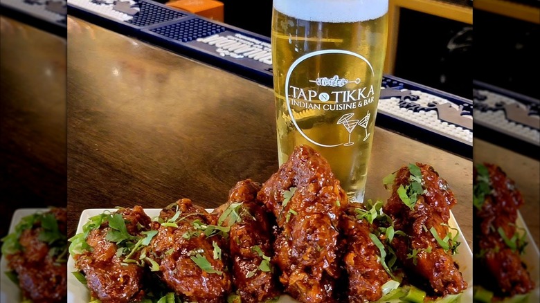 Crispy chicken with a beer on a bar