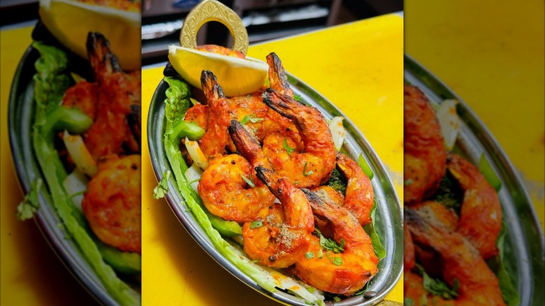 Spicy Shrimp dish with a lemon wedge at Tandoori Eats