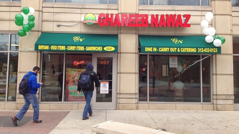 Customers enter Ghareeb Nawaz during grand opening