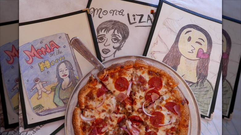 Mona Lisa illustrations on yellow brick wall