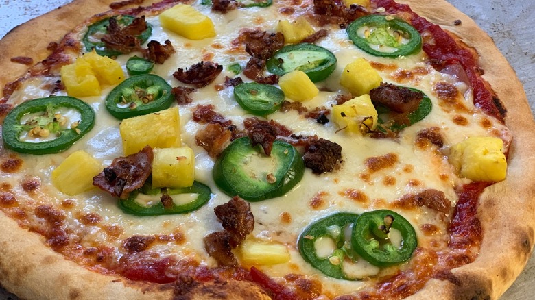 Whole pizza with bacon, jalapeños, and pineapple from The Hungry Robot