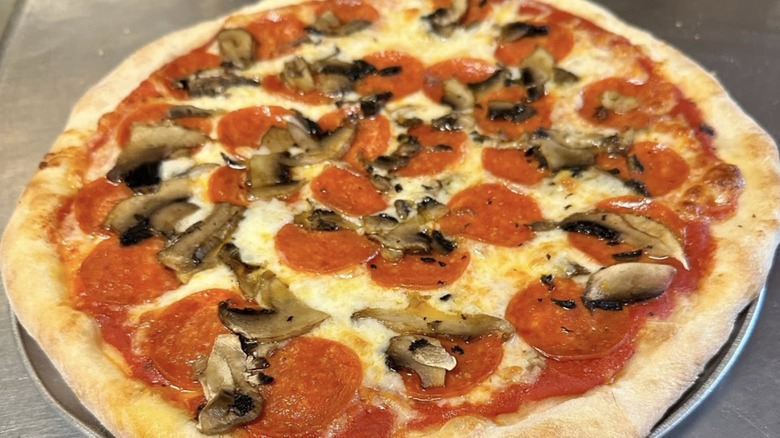 Whole pizza with pepperoni and mushroom from Iriana's Pizza