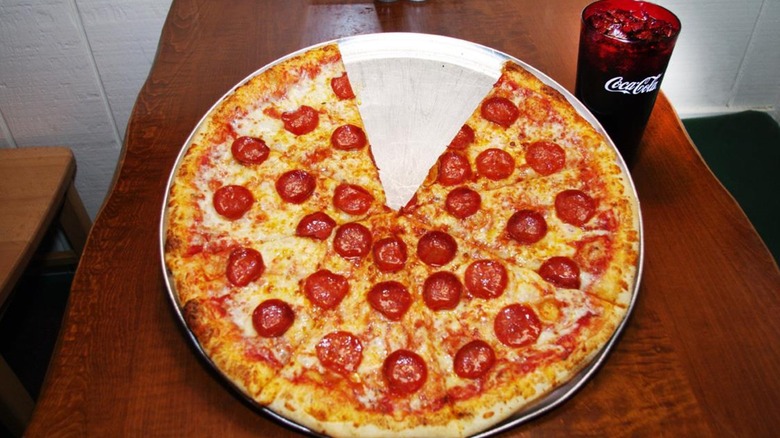 Whole pepperoni pizza with a slice missing from Big Bill's New York Pizza