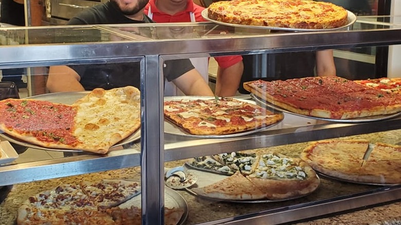 Various pizzas on display at counter at Cafe Sitaly