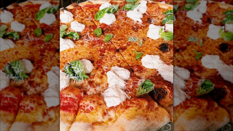 Pizza topped with fresh mozzarella and basil from Forbidden Pizza