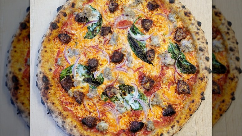 Whole pizza with basil and onions from Northern Fires Pizza