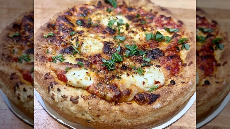 Whole pizza with fresh herbs and cheese from Engine Room Pizza