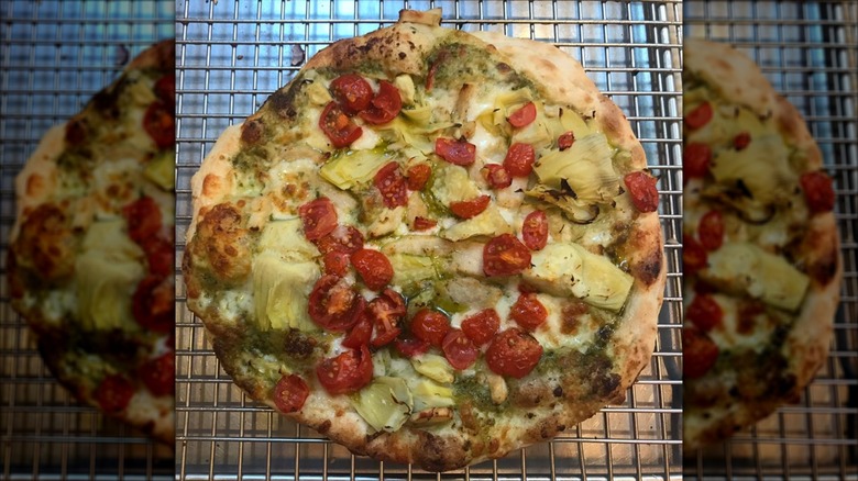 Whole pesto pizza with fresh tomatoes from Tasty Pizza