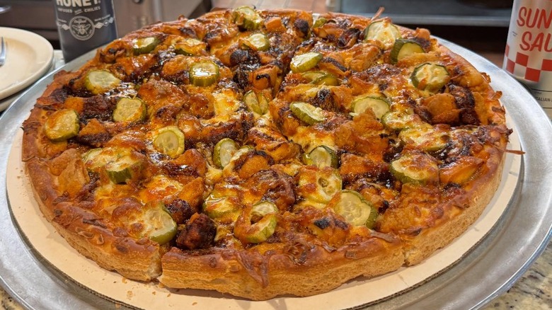 Whole Nashville Hot Honey Chicken Pizza, consisting of Crispy Chicken, Nashville Hot Sauce, Pickles, and finished off with a drizzle Hot Honey, from Tilton House of Pizza