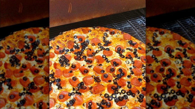 Whole pizza with cheese, pepperoni, and olives from Giovanni's Pizzeria