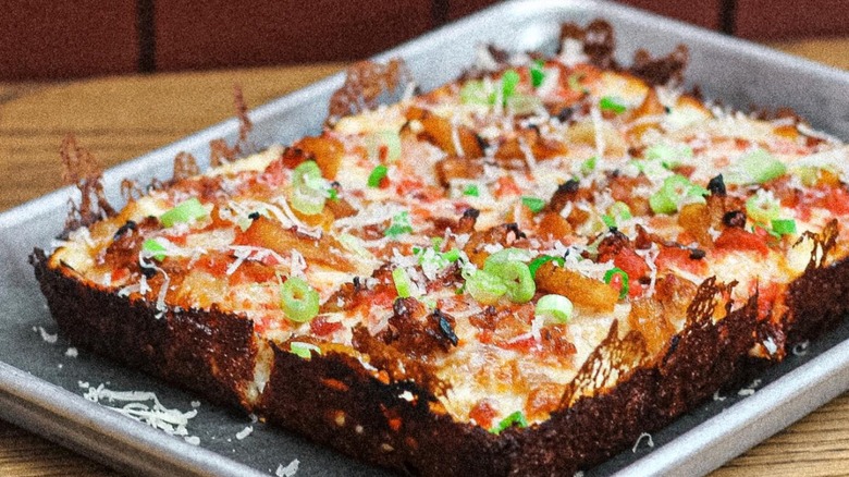 Whole Detroit-Syle Hawaiian-style pizza called "The Polynesian"  with caramelized pineapple, pacific marinara, bacon , shaved white onion, scallion, parm, from A Guy & His Pie