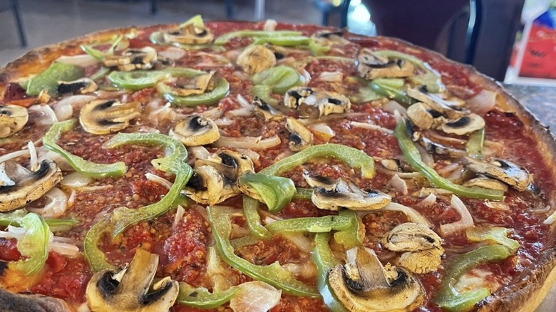 Whole pizza with green peppers, mushrooms and onion from Big Red's Colbert Trading Company