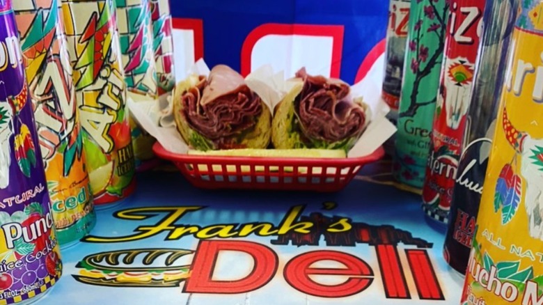 Frank's New York Style Deli sandiwch with assorted Arizona brand drinks on a table