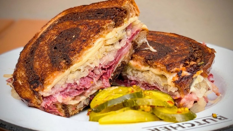 Cochon Butcher sandwich with Corned beef, Swiss cheese, sauerkraut and Russian dressing on marbled rye