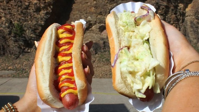 hands holding hot dogs from The Original ScoopDog
